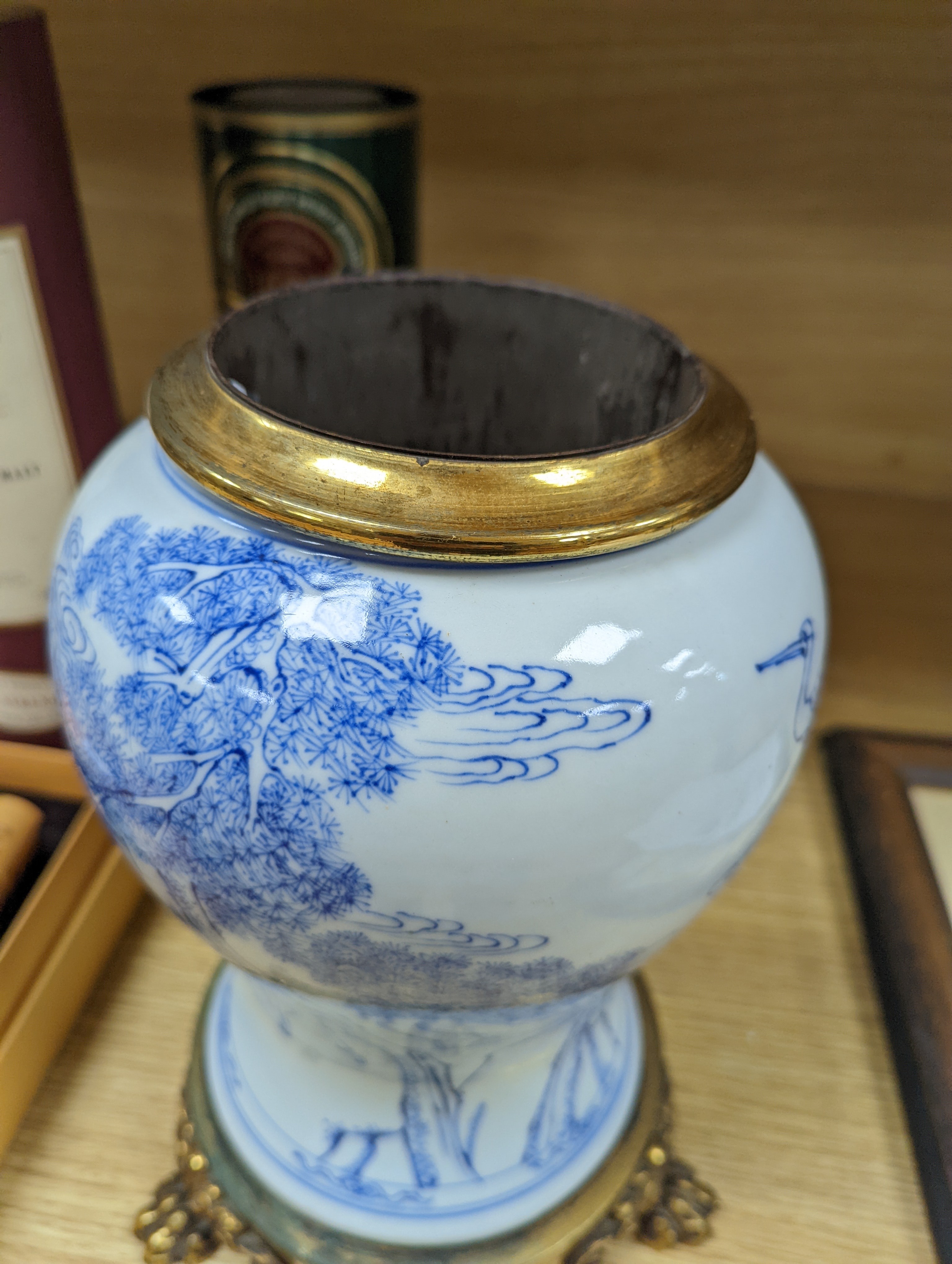 A Chinese blue and white baluster vase, brass mounted 29cm